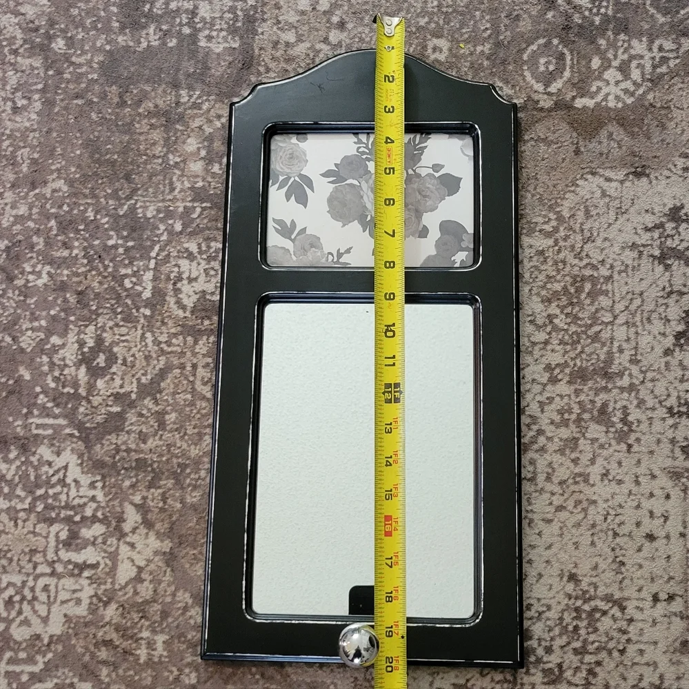 Elegant Black Wall Mirror with Floral Accent